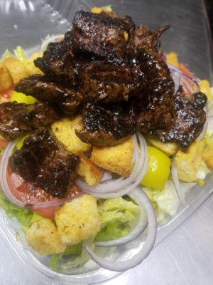 Steak Tips Over Garden Salad Image