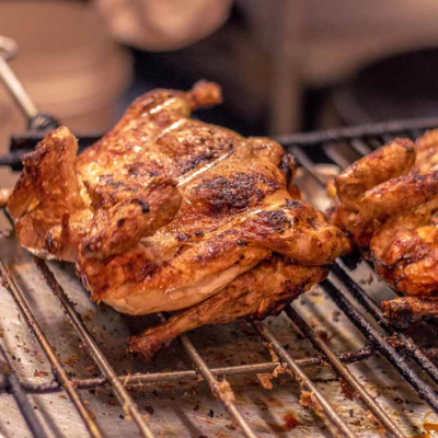 Chicken On Wood Charcoal Grill Image